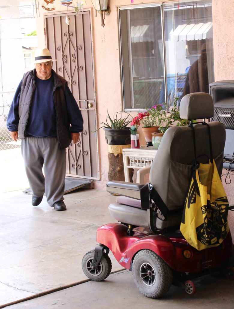Walking toward one of two mobile chairs relied upon to get around.